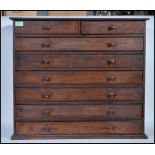 A early 20th Century stain pine specimen chest of drawers. Raised on a plinth base having two