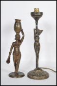 Two 20th Century cast bronze table lamps to in the form of female figures to include an African