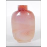 A late 19th / early 20th Century Chinese carved pink agate snuff bottle of tapering form, missing