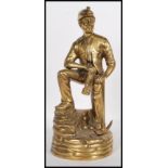A vintage mid-20th century brass statue of a coal miner. Depicted in full mining gear, complete with