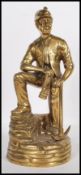 A vintage mid-20th century brass statue of a coal miner. Depicted in full mining gear, complete with