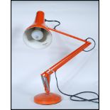 A vintage 20th Century Herbert Terry Industrial anglepoise desk lamp in an orange colourway,