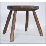 A 19th Century country rustic primitive elm rectangular milking stool, plank top raised on four