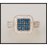 A hallmarked 9ct gold dress ring having a square head set with a square cluster of blue stones