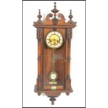 A 20th Century spring driven eight day wall hanging Vienna regulator, the walnut case surmounted