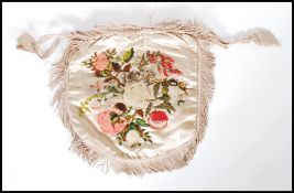 An early 19th Century Regency reticule silk purse having drawstring closure to the top with tasseled