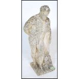 A 20th Century well weathered reconstituted stone garden statue figure of Hercules, leaning