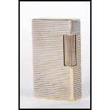 A vintage 20th Century Dupont of Paris white metal pocket lighter having striped decorated body.
