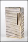 A vintage 20th Century Dupont of Paris white metal pocket lighter having striped decorated body.