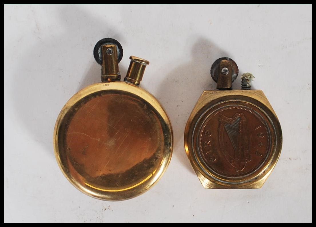 Two 20th Century military WW2 trench art brass lighters of round form one inset with a British coin, - Image 2 of 5