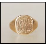 A 9ct gold signet ring having a cushion shaped panel head engraved with with initials. Assay marks