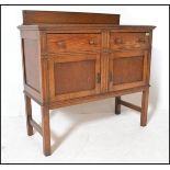 An early 20th Century Edwardian oak sideboard / credenza, gallery back with flared top over two