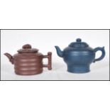 Two Chinese Yixing terracotta teapots comprising of a brown example with ribbed decoration and