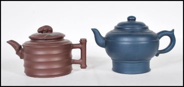 Two Chinese Yixing terracotta teapots comprising of a brown example with ribbed decoration and