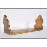 A late 19th / early 20th Century metamorphic gilt wood bookend having a central patterned centre