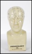A 20th Century desk top phrenology head ornament of small proportions having printed annotations.