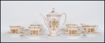 A vintage Noritake bone china coffee service having a pink ground with gilt decoration. Consists