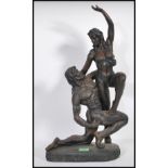 Two contemporary composite figurines of naked lovers, the first of a naked female held aloft