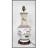 A Chinese Republic period famille rose painted vase of bulbous onion form, decorated with court