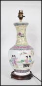 A Chinese Republic period famille rose painted vase of bulbous onion form, decorated with court