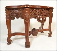 A contemporary 20th Century Burmese carved hardwood shaped front console table, frieze carved and