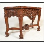 A contemporary 20th Century Burmese carved hardwood shaped front console table, frieze carved and