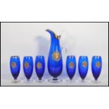 A 20th Century continental blue glass lemonade set having gilt decorated rims with applied crests to
