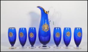 A 20th Century continental blue glass lemonade set having gilt decorated rims with applied crests to