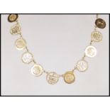 A 9ct yellow gold Chinese necklace having a total of eleven tokens modeled as Chinese coins and