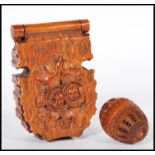 A 20th Century carved coquilla nut pomander case being carved with concentric circle patterning with