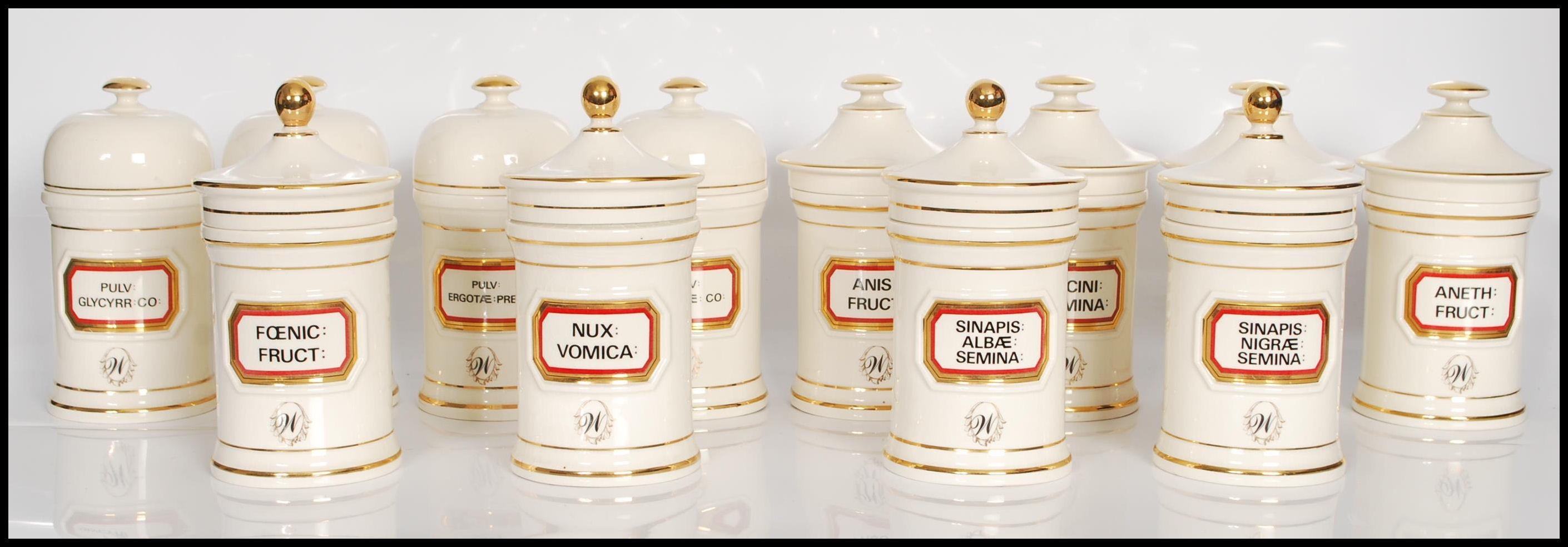 A group of twelve 20th Century Chalsyn Ltd ceramic apothecary jars and covers all having white