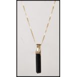 A stamped 750 18ct gold fine box link necklace chain having a black crystal pendant. Weight 3.5g.