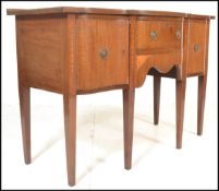 A 19th Century Georgian George III mahogany and inlaid serpentine fronted sideboard, central