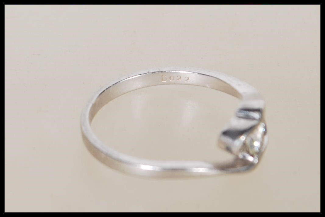 A 950 platinum solitaire diamond ring having an openwork swirl mount set with a single diamond - Image 6 of 6