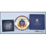 A collection of items to include a Royal Mint Commemorative plate by Royal Worcester commemorating