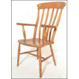 A 19th Century Victorian elm and beechwood Windsor farmhouse elbow chair, lath back above out