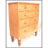 A 19th century Victorian scrubbed pine two short over two long chest of drawers, turned handles