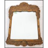 A late 19th Century Victorian rococo style gesso gilt framed wall mirror of rectangular form