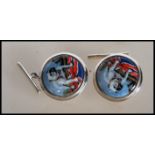 A pair of stamped 925 silver cufflinks having central enamelled panel decoration depicting a British