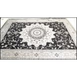 A large Persian floor carpet Abusson rug having a grey ground with geometric borders and central