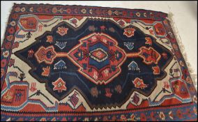 A 20th Century Persian Islamic multi coloured Kelim / Kilim woven floor rug having central medalon