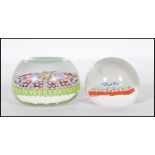 Two 20th Century paperweights to include a smaller glass domed paperweight with a coloured