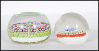 Two 20th Century paperweights to include a smaller glass domed paperweight with a coloured
