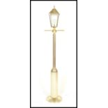A retro 20th Century upright floor standard lamp in the style of a Victorian street lamp having a