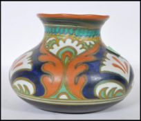 A 20th Century Gouda pottery vase of squat form in the Ali pattern. Signed to the base 6Y ALi,