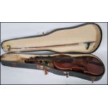 A early 20th Century cased violin musical instrument having a two piece maple back with spruce