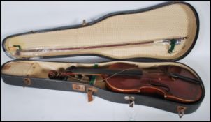 A early 20th Century cased violin musical instrument having a two piece maple back with spruce