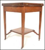 An early 20th Century Edwardian mahogany envelope card table, the top swivelling round to reveal