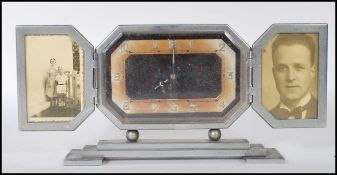 A early 20th Century 1930's Art Deco table desk clock having two hinged fold out doors turning