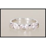 A hallmarked 9ct white gold ring set with three oval cut pink stones. Hallmarks for Birmingham